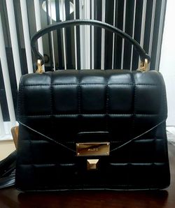 Aldo black quilted satchel is the Kamelia top handle handbag.