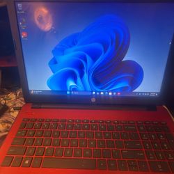 HP 15-series red laptop running Windows 11 15.5 in Display Touch HD