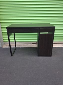 Black desk with drawers and shelfs