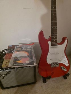 Electric guitar with amp fender and accessories.