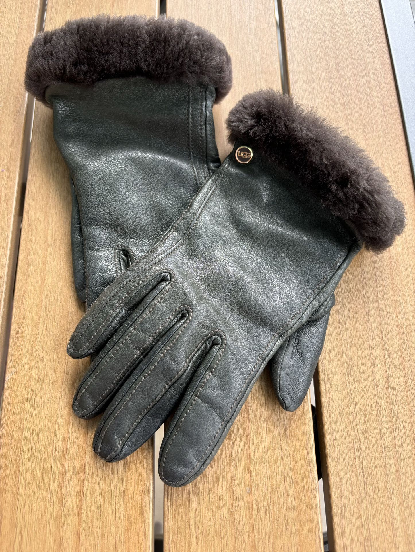 UGG brand leather gloves for women , sheepskin collar and knit insert.  The color olive green with brown fur and metal gold logo UGG  In very good con