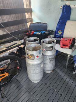 Three aluminum forklift propane tanks