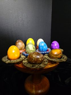 Eight polished mineral eggs made from various stones like marble and alabaster