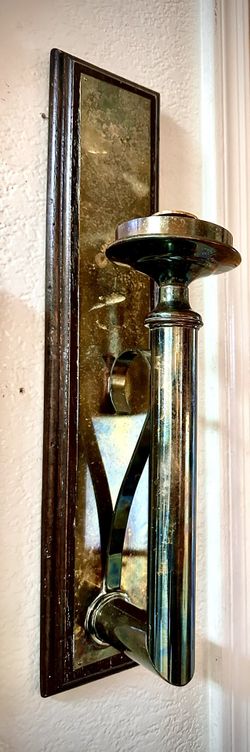 Beautiful and elegant set of two wall mounted candle holders with dimensions H19xL4xD5.5 inch LbsSet 5.6. This is a beautiful set made of brass on woo