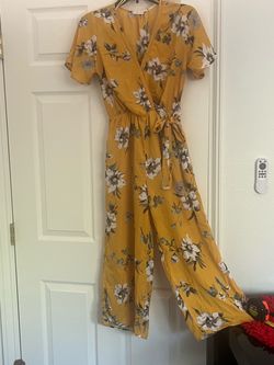 Women's Clothing Bundle: Floral Jumpsuit and Shorts  Versatile three-piece clothing set includes a mustard yellow floral print jumpsuit, black athleti