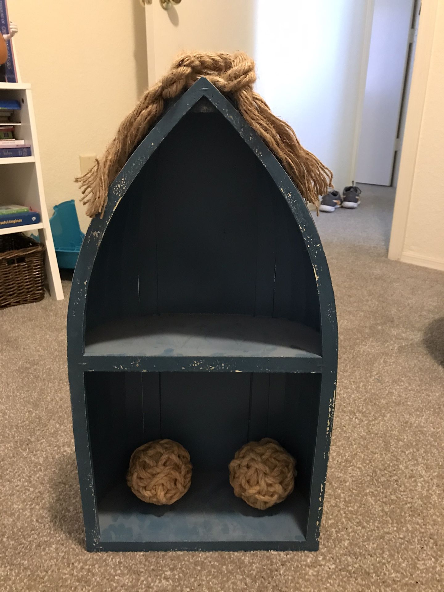 Wooden boat bookshelf and metal captain sign