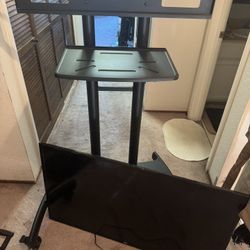 Rolling TV stand with 48 inch TCL SMART TV.