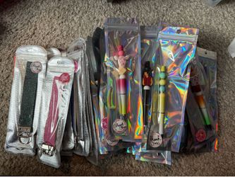 Large assortment of pens and keychains