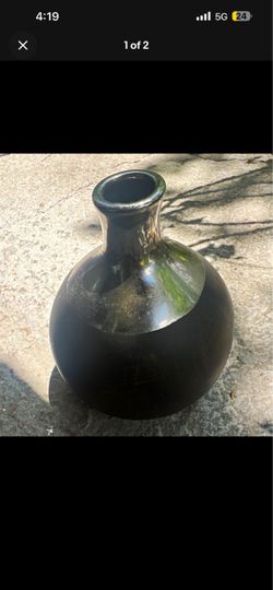 ceramic vase features a distinctive two-toned black finish with a modern, minimalist silhouette.