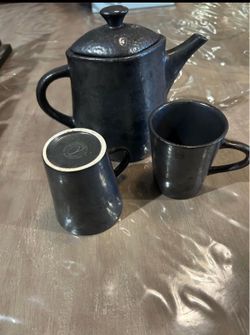 Black pitcher with two cups