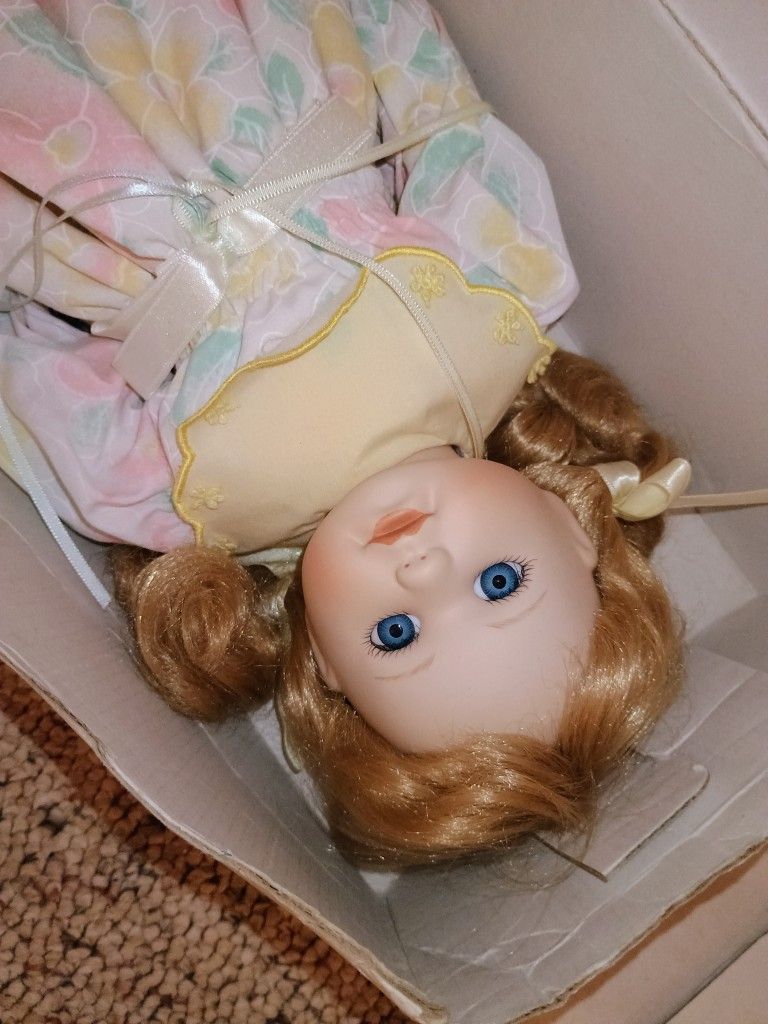 Porcelain Doll In The Box With A Little Baby