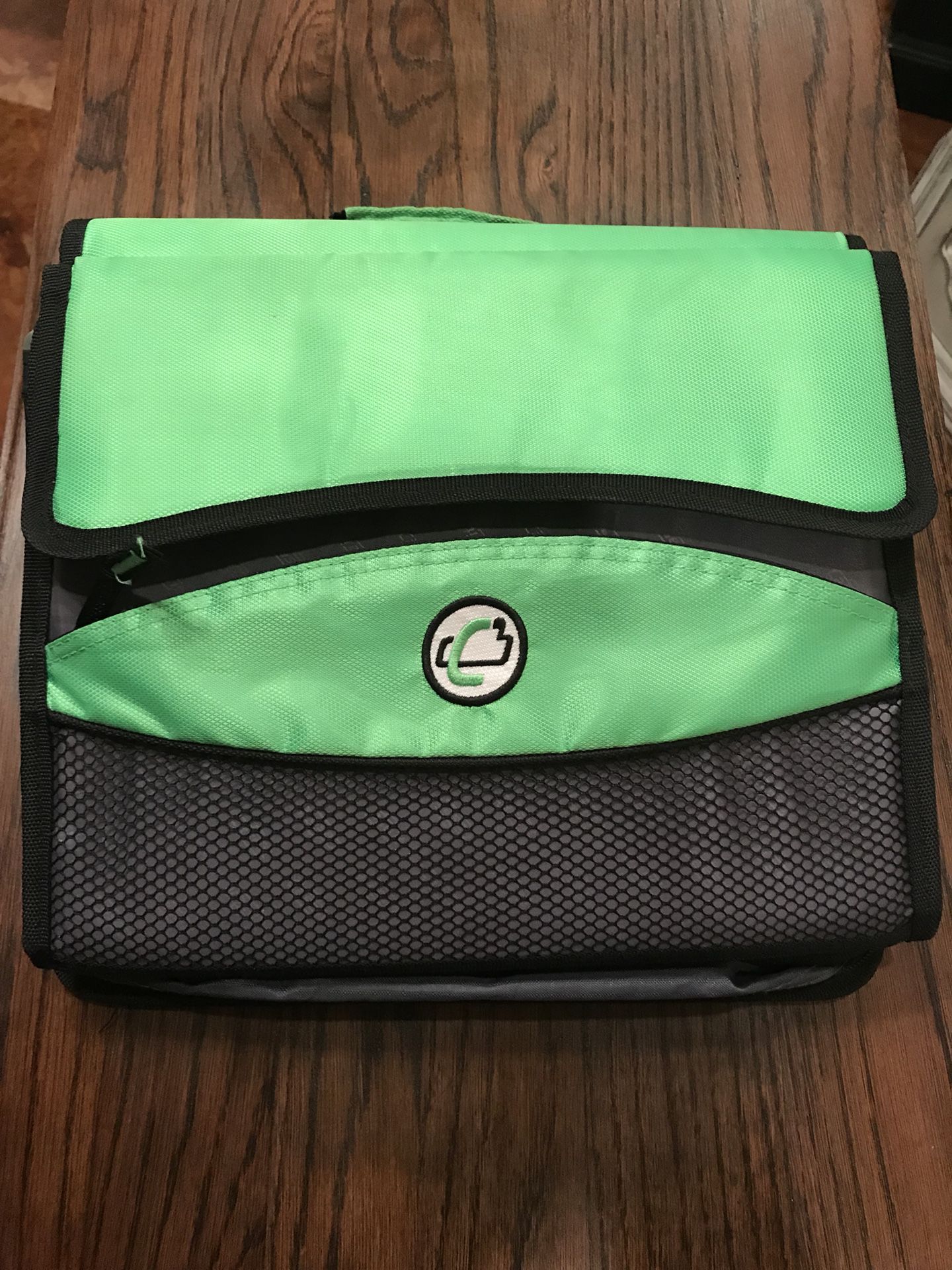 Lime green zip up binder with filing attachment.