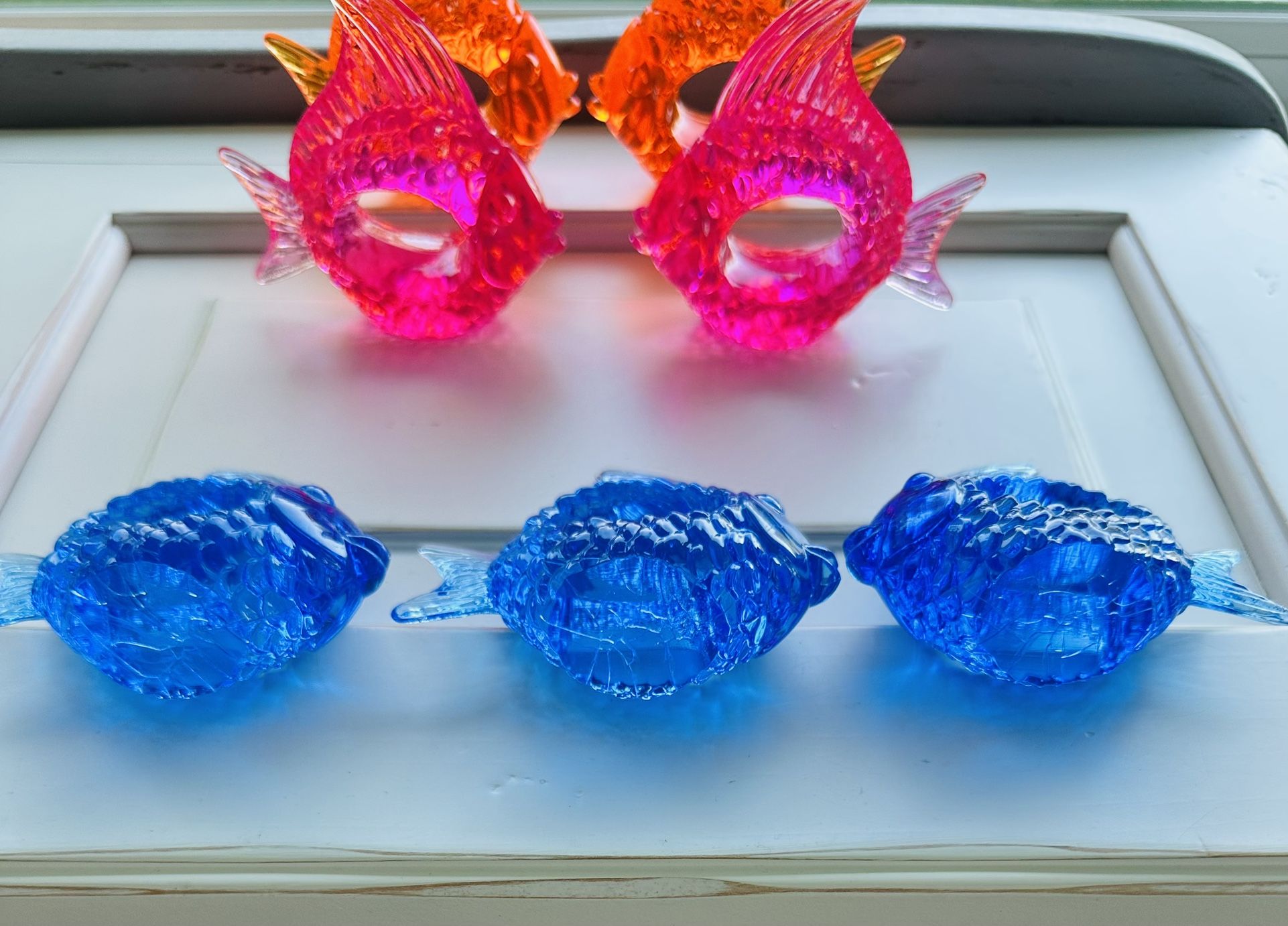Vintage set of 11 translucent lucite napkin rings shaped like angel kissing fish.