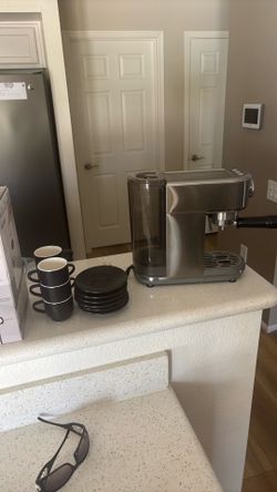 Espresso machine with cups and saucers