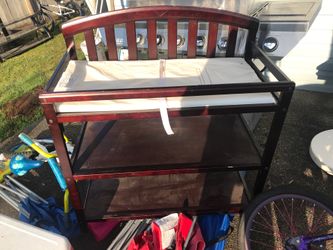 Red wood change table w/ shelves