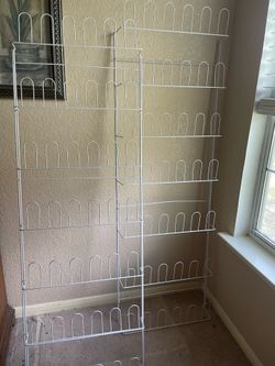 Wall mount shoe racks=both total is 42 pairs; each rack holds 21 pairs. (Ad is wire racks only; Need wall brackets to mount