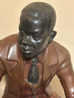 Large metal statue/sculpture of man sitting on barrel