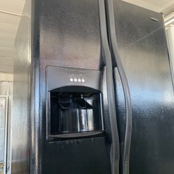 Black side-by-side refrigerator made by Frigidaire comes with warranty