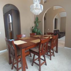 Amish Handmade Table and six bistro style swivel chairs and pads. 