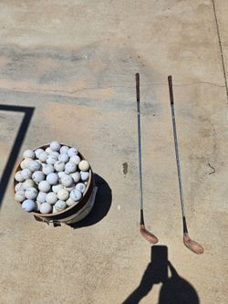 Bucket of golf balls with golf clubs