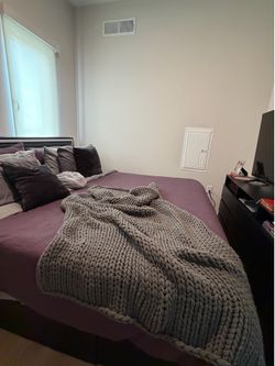 Leather bed , mattress and a black dresser