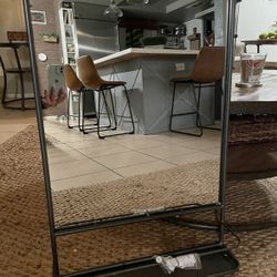 Mirror with a built-in storage shelf