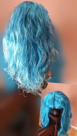 Vibrant, long, wavy, punky, blue wig, With Bangs approximately 25" length.