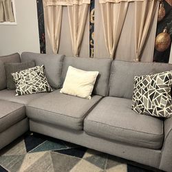 Gray Sectional Sofa with Decorative pillows and Rug