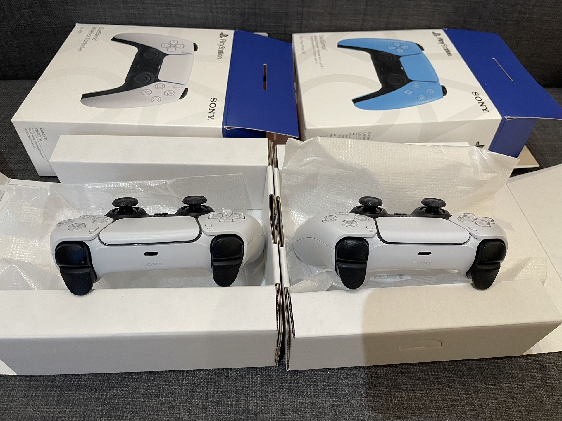 Two White PS5 Controllers