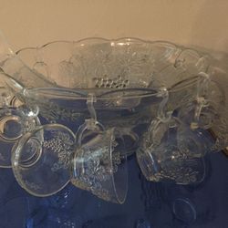 Pressed glass punch bowl grape design with 12 glasses and hangers plus large plastic punch bowl ladle.