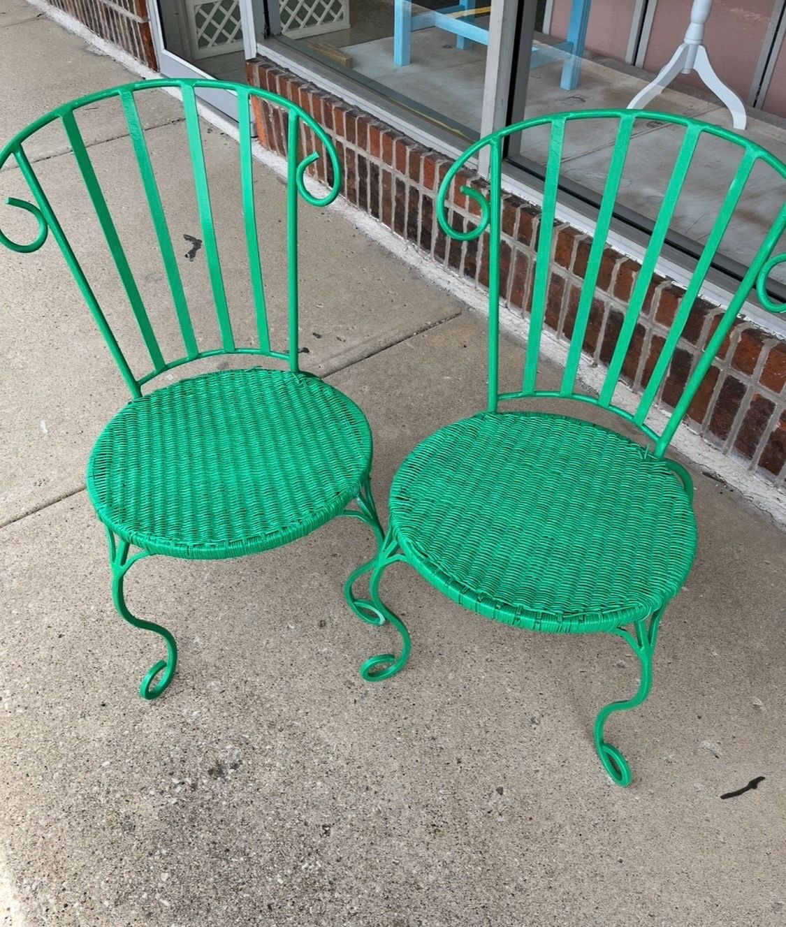 Two green patio chairs