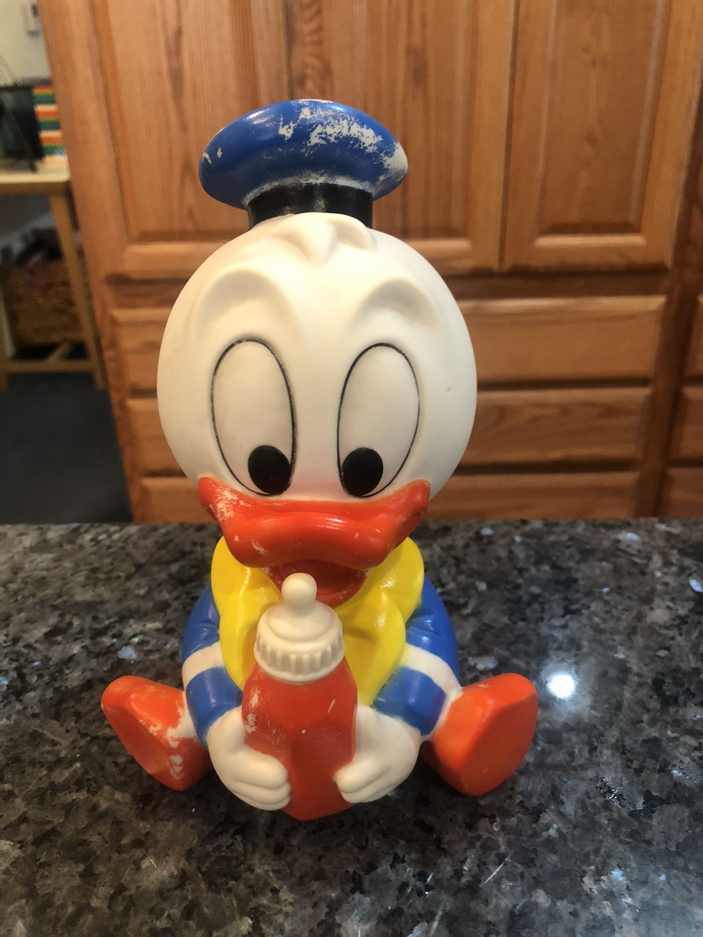 Vintage Disney Baby Donald Duck Soft Rubber Squeaky Toy with a bottle. Size 8 inches tall. Preowned. Year 1984 Walt Disney Company. Nice edition t