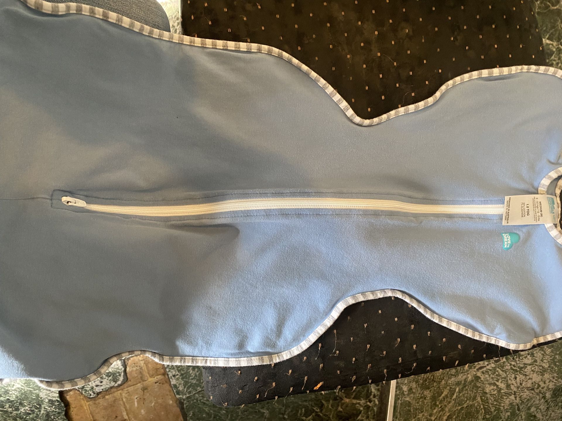 Swaddle size medium used a little tear in the back good condition 
