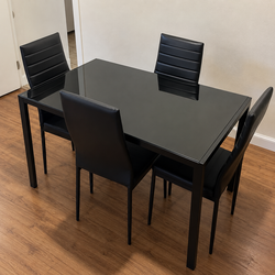 Black rectangular dining table with 4 chairs