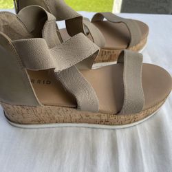 Torrid Tan Wedge Sandals with Cork Midsole, Women’s Size 9W  Step into comfort and style with these Torrid wedges, showcasing a versatile tan hue and 