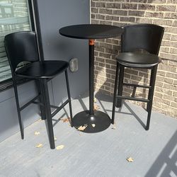 Two high top chairs and a table