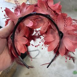 Red Floral Headband Decorative headband with red flowers and feathers.