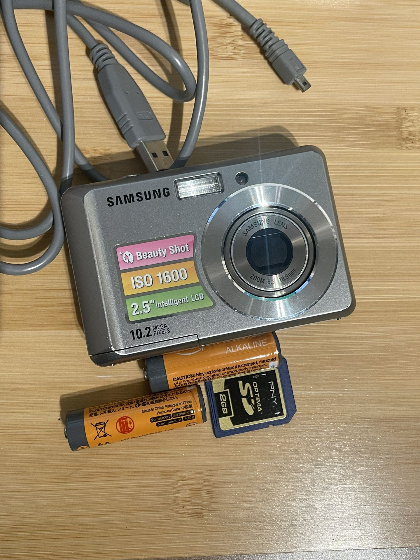 Samsung SL30 digital camera 10.2 Mp Tested Works  Flash zoom video shutter all working. Batteries, memory card and USB cord included