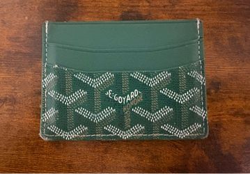 Green wallet with white stitching