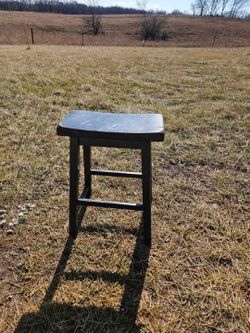 black wooden saddle seat bar stool