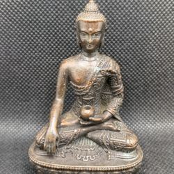 Antique and collectible Buddhist statues and decorative items for home display.