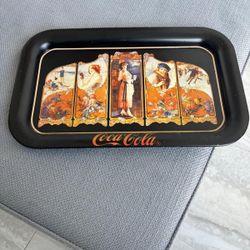 The item is a vintage Coca-Cola serving tray, a reproduction of a 1923 design …copyrighted  in 1990… 14 “ x 9”. $20