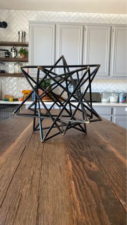 Black decor metal star with golden tips 15 inches wide 14 inches tall