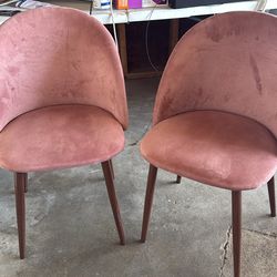 2 pink suede chairs