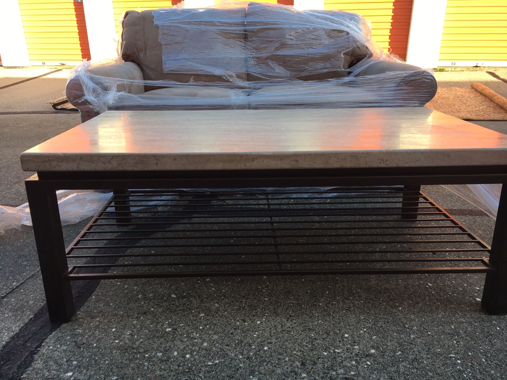 Heavy marble coffee table with iron base, purchased at Macy’s . 50”L x 28”W x 19”H. Cleaning out storage facility.