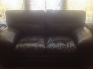 Photo Leather love seat in good condition, sold with sofa, sofa table and two end tables, round kitchen table and four chairs. Can be sold as a package or