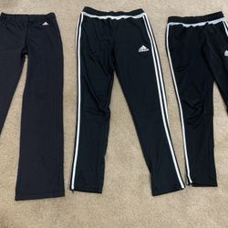 Multiple Pairs Of Adidas Pants Sizes Are From Left To Right Large Xl And Large