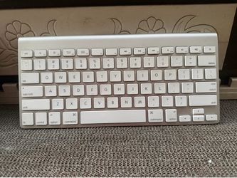Apple Wireless Keyboard model A1314, featuring a sleek silver aluminum finish and white chiclet keys.