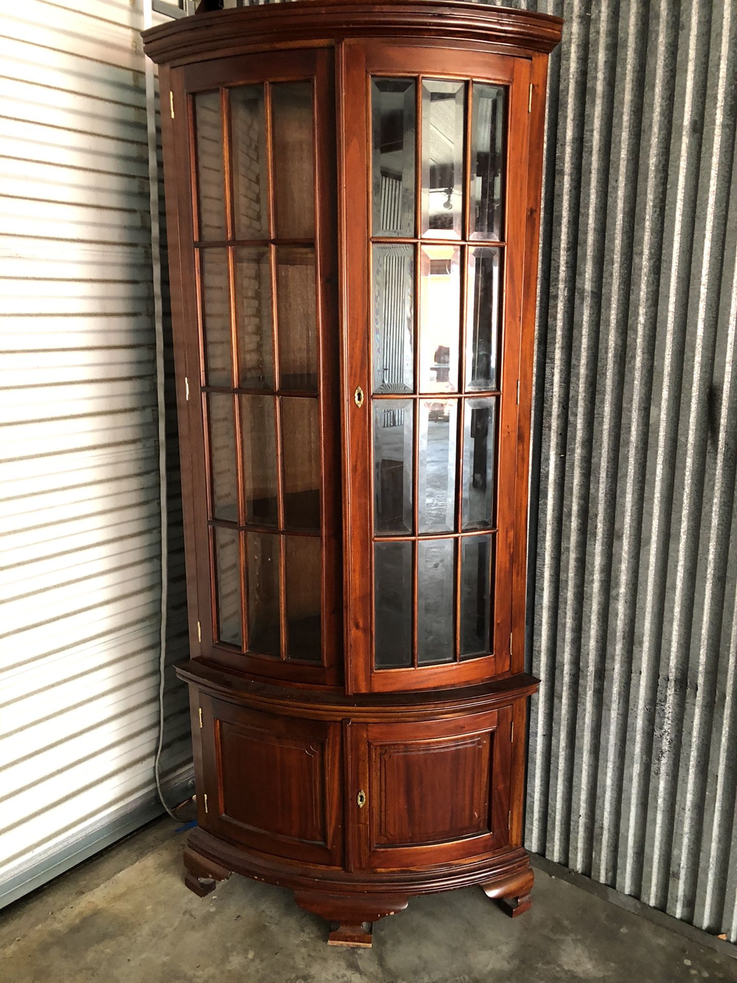 Corner wood cabinet 4 shelves top and storage on bottom with key Glass panels curved look 78.75” h