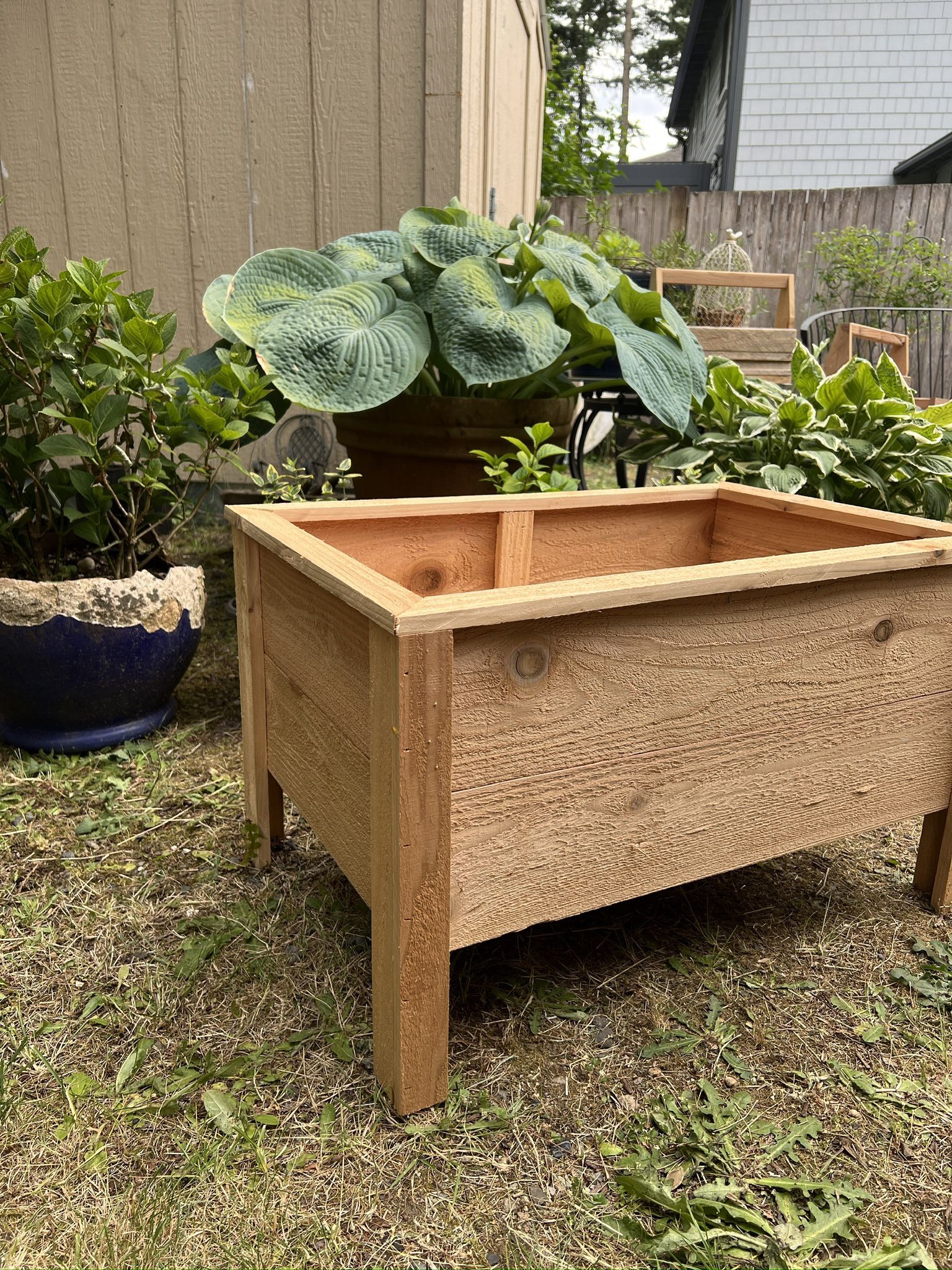  A container made of cedar wood designed for planting flowers & More.